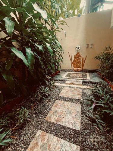 a garden with a stone walkway with plants at Tangkoko Sanctuary Villa in Bitung