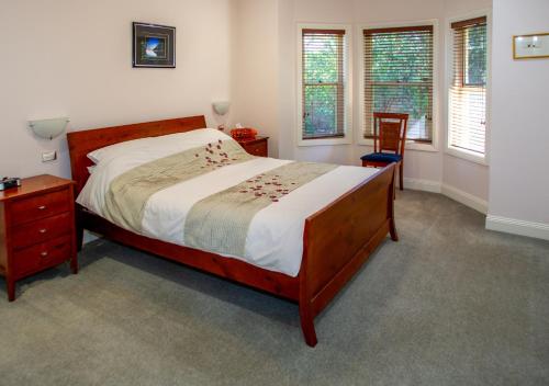 a bedroom with a bed and a table and a chair at Lochnagar Barossa in Tanunda