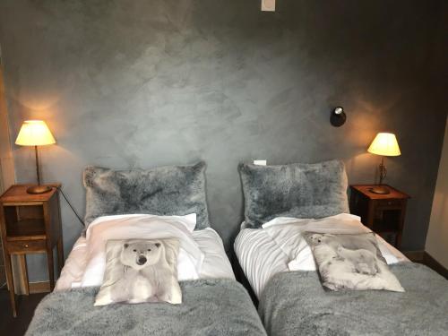 a bedroom with two beds with a dog laying on the pillows at Appartement Valloire, 4 pièces, 8 personnes - FR-1-263-214 in Valloire