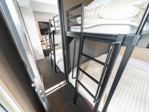 a group of bunk beds in a dorm room at Super Hotel Mitazono Sendai Airport in Natori