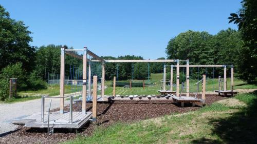 a park with a playground with a swing set at Ferienhof Guglhupf in Sankt Oswald
