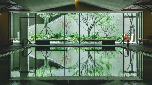 a pool of water in the middle of a building at Mumian Chengdu Dong'an Lake in Chengdu