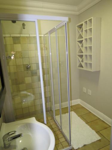 a bathroom with a shower and a sink at Olden Rose Place in Lephalale