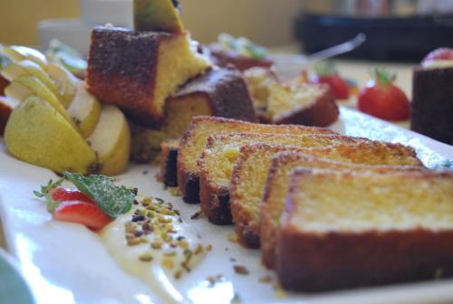 a plate of food with bread and fruit on it at Hotel Acerboli in Rimini