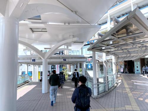a group of people walking through a building at SKYE HOME in Tokyo