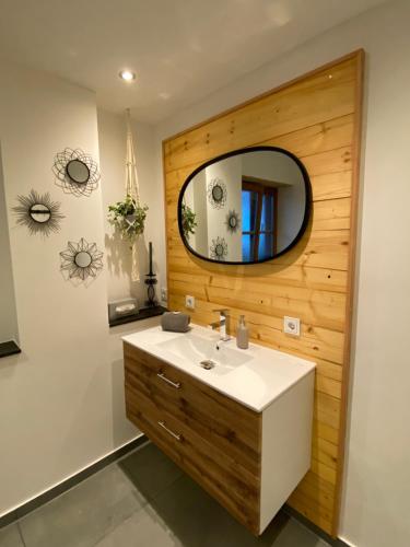 a bathroom with a sink and a mirror at Ferienwohnung Räsl in Holzkirchen