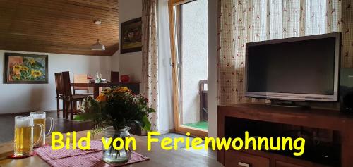 a living room filled with furniture and a tv at Terrassen-Camping am Richterbichl in Rottenbuch