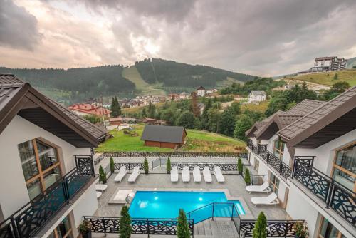a view from a balcony of a house with a swimming pool at Chalet Fomich in Bukovel