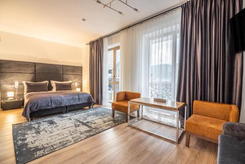a bedroom with a bed and a table at Chalet Fomich in Bukovel