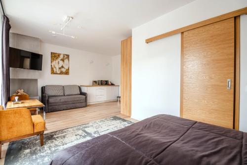 a bedroom with a bed and a living room at Chalet Fomich in Bukovel