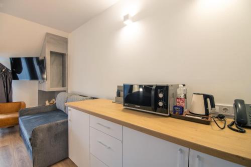 a kitchen with a counter top with a microwave at Chalet Fomich in Bukovel