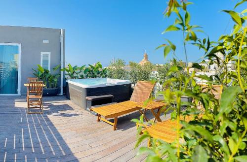 a deck with chairs and a hot tub on a house at Casa Reale Boutique Hotel in Valletta