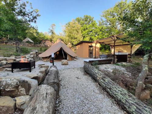 a large tent in a yard with a fence at Agriturismo e Glamping Serraiola Alta in Frassine