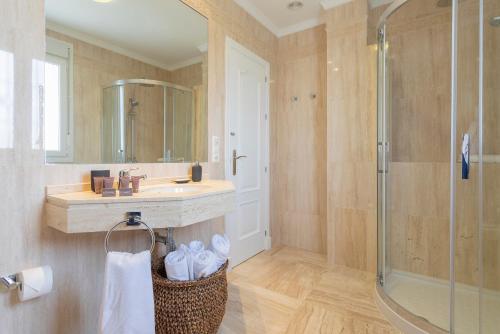a bathroom with a sink and a shower at Genteel Home Mirador de La Barrosa in Chiclana de la Frontera