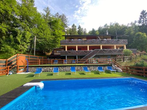 a house with a swimming pool in front of a house at Le Terrazze sul Lago - Ledro House in Pieve Di Ledro