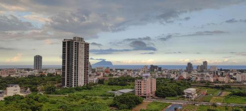 a view of a city with a tall building at 晨曦溫泉宅 in Toucheng