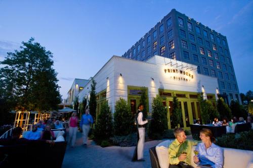 a group of people sitting outside of a building at Proximity Hotel in Greensboro