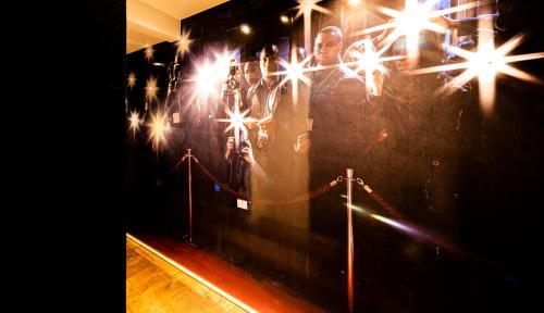 a wall with a picture of a man with lights on it at Romantik Hotel Walhalla in Osnabrück