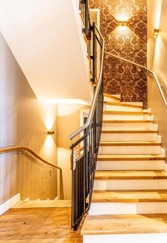 a set of stairs in a house with a chandelier at Romantik Hotel Walhalla in Osnabrück