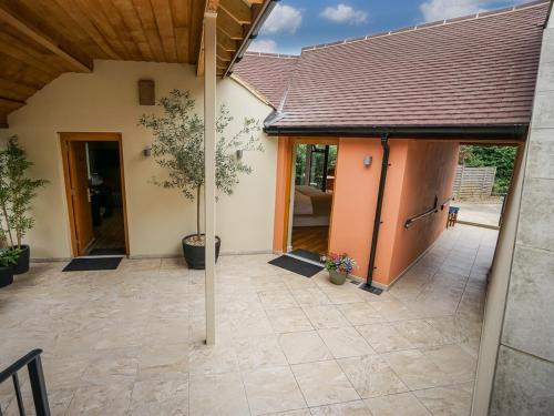 an open patio with a house with a roof at The Bakery Restaurant with Rooms in Westerham