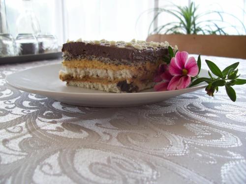 a piece of cake on a plate on a table at Pensiunea Mara in Deseşti