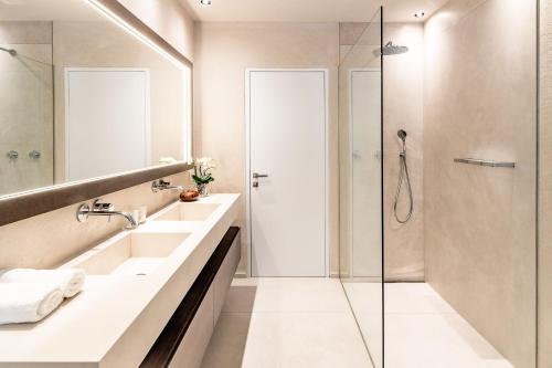 a bathroom with two sinks and a shower at Schenna Chalet - Chalet Penthouse in Schenna