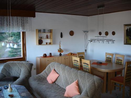 a living room with a couch and a table at Haus Brockenblick in Gehlberg