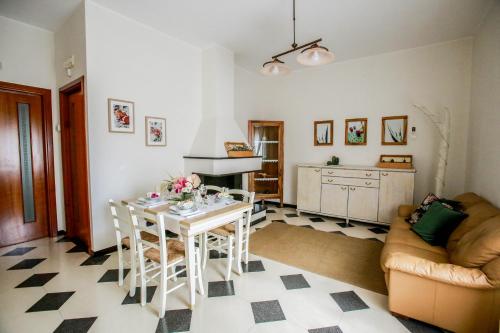 eine Küche und ein Wohnzimmer mit einem Tisch und Stühlen in der Unterkunft Appartamento ellea resort in San Michele Salentino