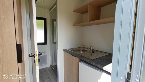 a kitchen with a sink and a counter top at Camping LE Moulin in La Motte-Chalançon