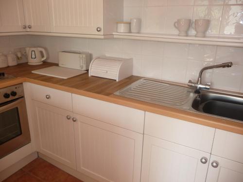 a kitchen counter with a sink and a toaster at Salisbury Old Mill House in Salisbury