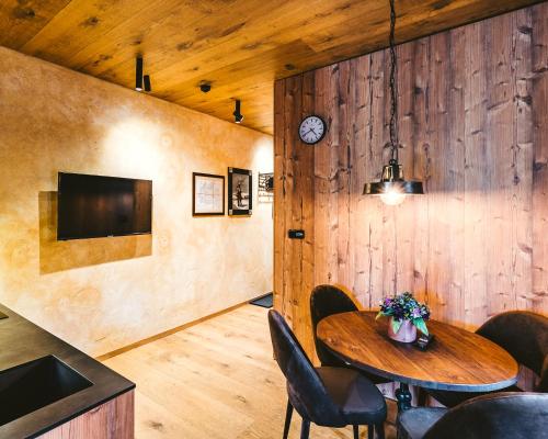 a dining room with a table and chairs at Aparthotel & Wellness Knížecí cesta in Horní Planá