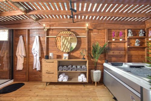 a bathroom with a sink and a wooden wall at אחוזה בהרים in Meron
