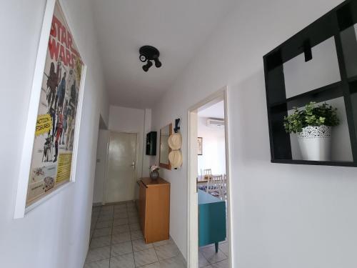 a hallway of a house with a ceiling fan at Cozy apartments with seafront terraces in Omiš