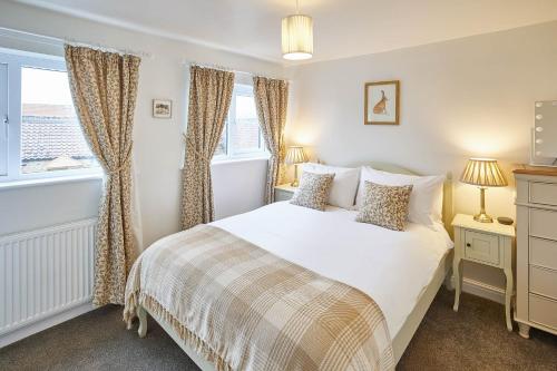a bedroom with a bed and a window at Host & Stay - Willow Cottage in Helmsley