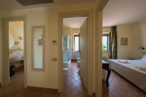 a bedroom with a bed and a bathroom at Hotel Scapolatiello in Cava deʼ Tirreni
