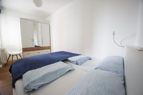 a bedroom with two beds and a dresser and a mirror at Oland Whg 13 Seestern in Wyk auf Föhr