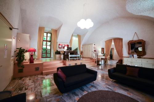 a large living room with a couch and a table at Hotel Trieste in Morbegno