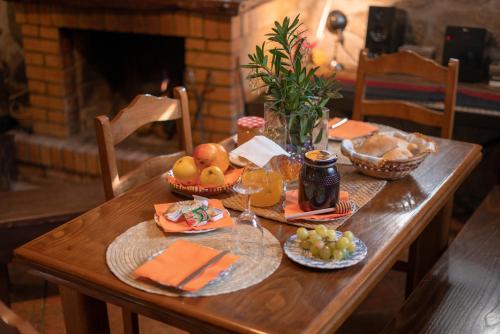 una mesa de madera con comida y fruta. en Casa da Eira, en Campo do Gerês