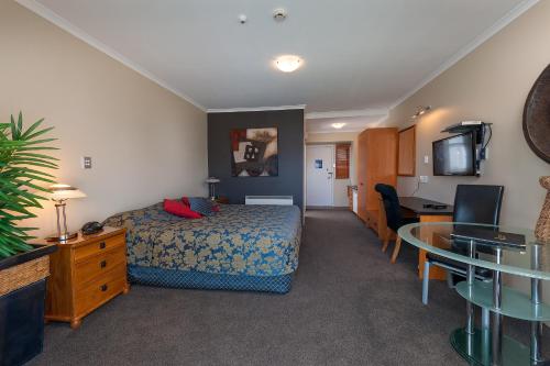 a hotel room with a bed and a table at Beachcomber Inn Picton in Picton