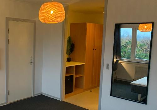 Habitación vacía con espejo y ventana en Camp Femern Bælt, en Søllested