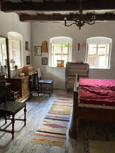 a bedroom with a bed and a table and chairs at Vándor Székely Vendégház in Nagybörzsöny