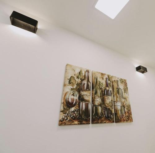 a painting of wine bottles hanging on a wall at Hotel Tanja in Banja Luka