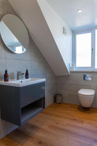 a bathroom with a sink and a mirror at Airds Apartments in Oban