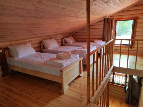 a room with two beds in a log cabin at Old Tbilisi Villa Costa in Tbilisi City
