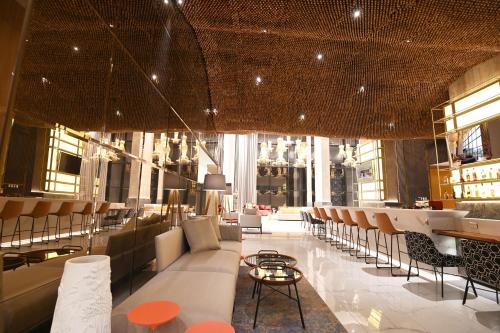 a lobby with chairs and a bar in a building at Novotel Santa Cruz De La Sierra in Santa Cruz de la Sierra