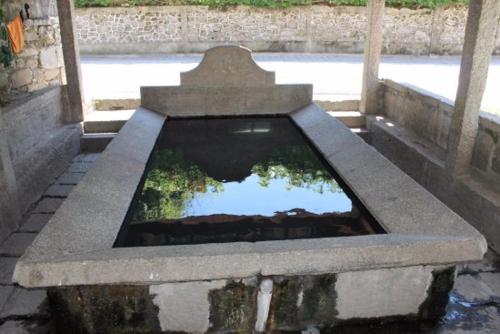 a reflection of a pond in a stone bench at Altamira in Caldas de Reis