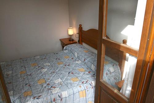 a bedroom with a bed and a lamp and a mirror at Ramonet in Son