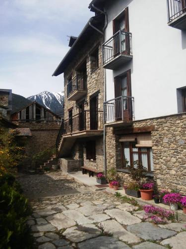 a stone building with balconies and flowers in front of it at Ramonet in Son