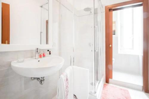 a white bathroom with a sink and a shower at La Risorgente B&B in Rome