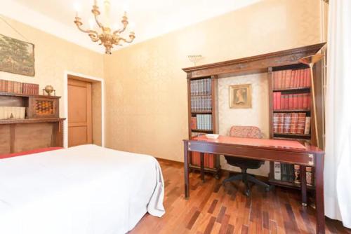 a bedroom with a bed and a desk and a piano at La Risorgente B&B in Rome